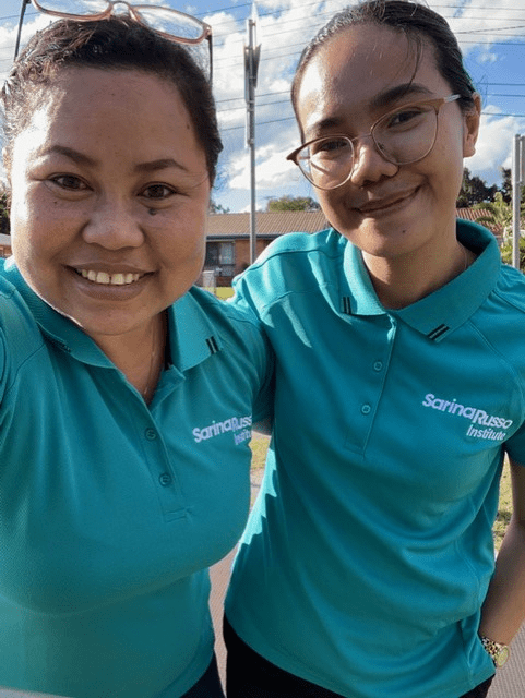 2 Sarina Russo Institute students pose outside of their vocational work placement